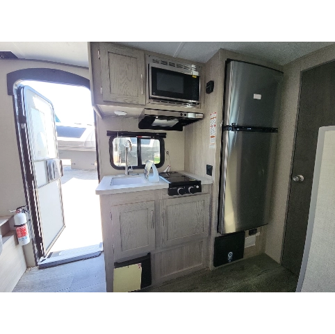 Kitchen of Coachmen Catalina Summit Series 7 RV- countertop, sink, microwave, stove, fridge, cabinets