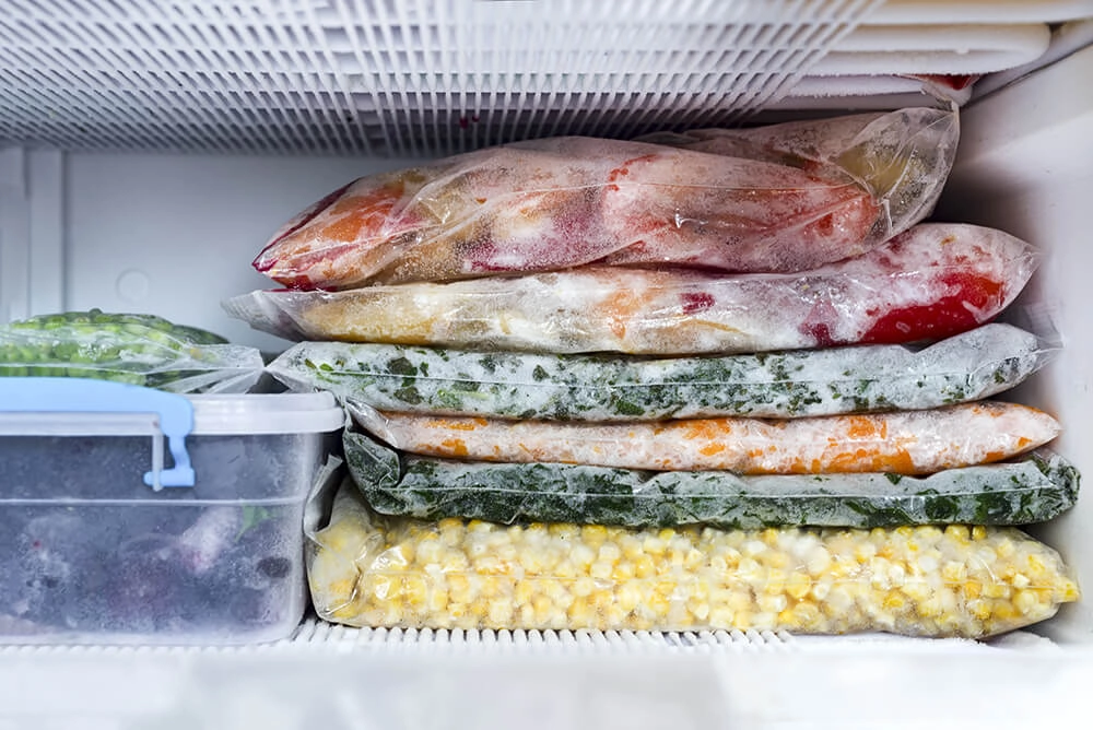 Pre-prepared meal and ingredient bags in freezer