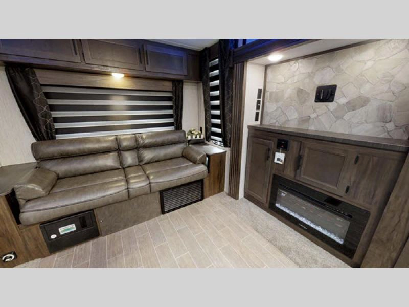 Cherokee Black Label travel trailer interior living area with sofa and fireplace