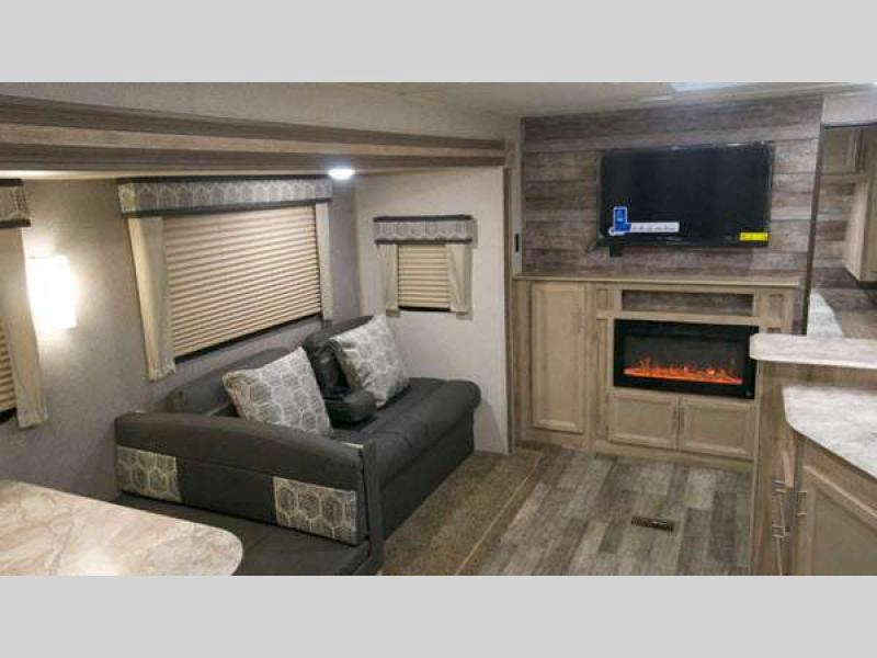 Catalina Legacy travel trailer interior living with soda, TV, and fireplace