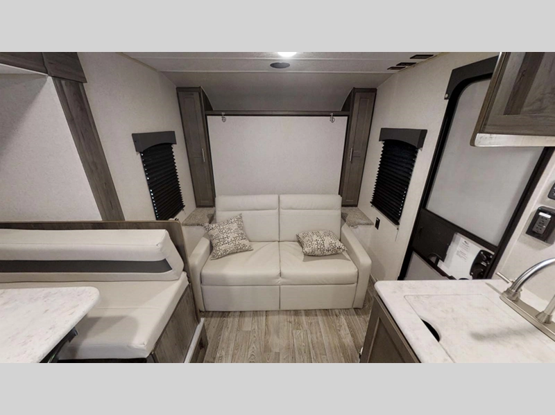 Clipper Ultra Lite travel trailer living room area with seating and murphy bed