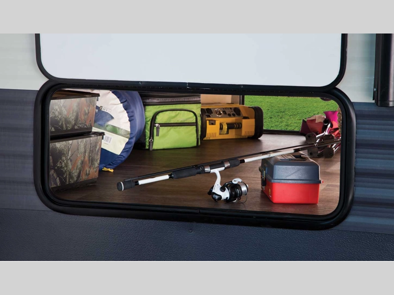 Puma Travel Trailer- exterior storage feature filled with camping gear