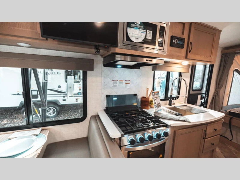 Galley Kitchen layout of a Solaire expandable RV showing stove, cabinets, sink, microwave, and counter space