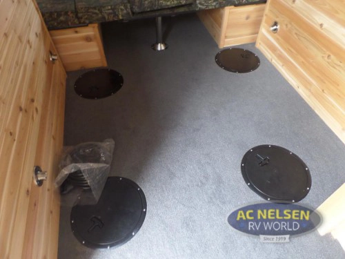 Ice Castle Fish House floor with multiple fishing hole covers